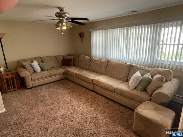 carpeted living room featuring visible vents and a ceiling fan