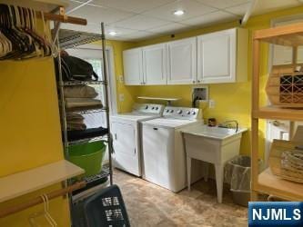 laundry area featuring recessed lighting, cabinet space, and washer and dryer