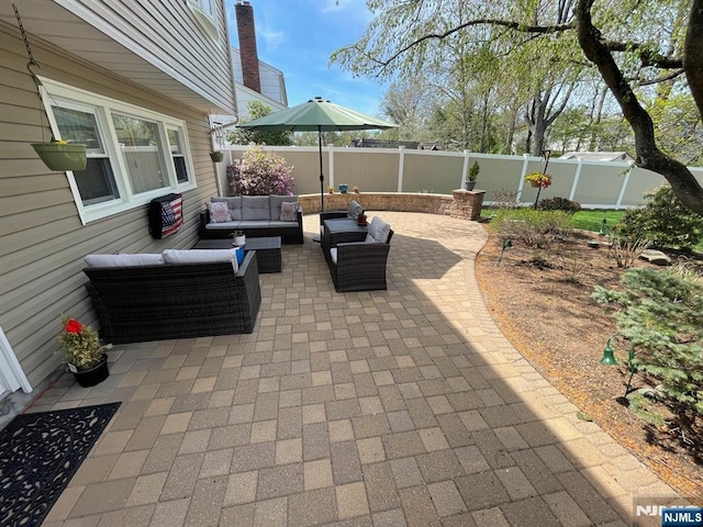 view of patio / terrace featuring an outdoor hangout area and a fenced backyard