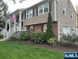 view of property exterior featuring a lawn and brick siding