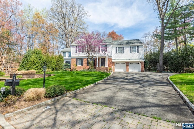 38 Farley Pl, Allendale, NJ 07401 - view of front of home featuring brick siding, a front lawn, driveway, and a garage