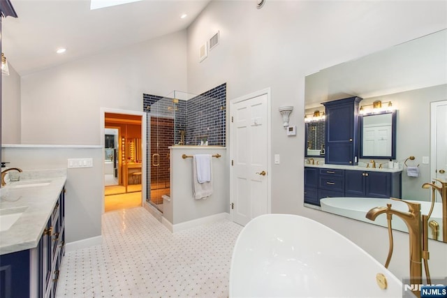 38 Farley Pl, Allendale, NJ 07401 - bathroom featuring a shower stall, a freestanding bath, double vanity, a sink, and high vaulted ceiling
