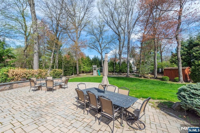 38 Farley Pl, Allendale, NJ 07401 - view of patio with a storage shed, an outbuilding, outdoor dining area, and a playground