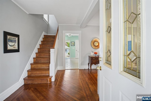 foyer entrance with ceiling fan, stairway, wood finished floors, and baseboards