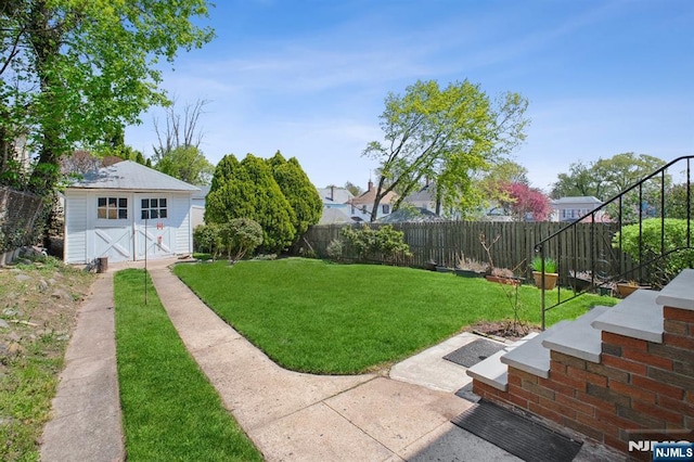 view of yard with a storage unit, a fenced backyard, and an outdoor structure