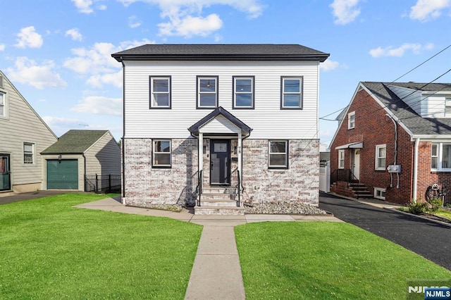 view of front of property with aphalt driveway, a front yard, entry steps, and brick siding