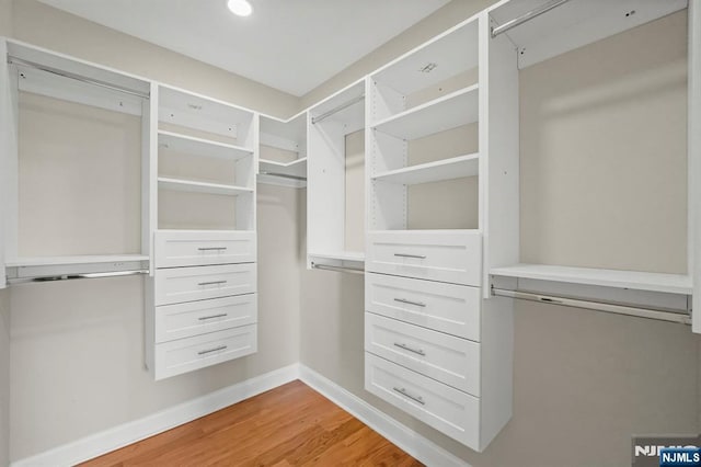 spacious closet with light wood finished floors