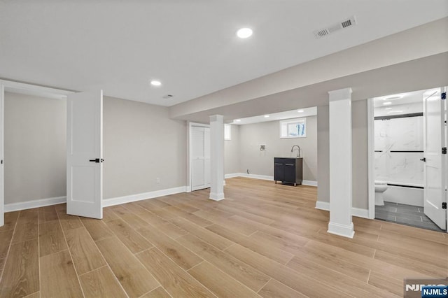 basement featuring visible vents, recessed lighting, and light wood-style floors