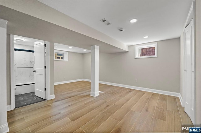 basement with recessed lighting, visible vents, light wood-style flooring, and baseboards