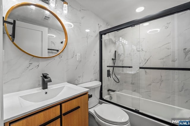 full bath featuring recessed lighting, combined bath / shower with glass door, toilet, vanity, and visible vents