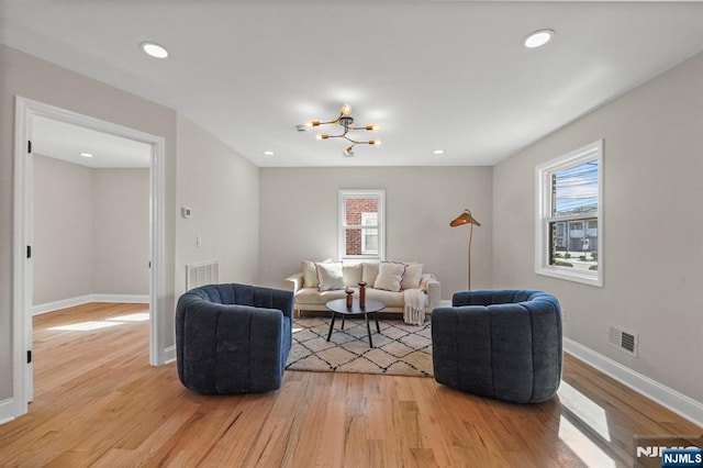 living room with visible vents, recessed lighting, light wood finished floors, and baseboards
