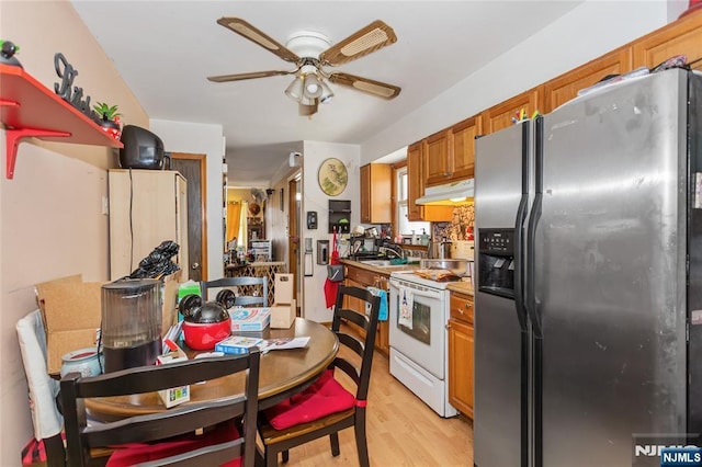 kitchen with ceiling fan, white electric stove, stainless steel fridge with ice dispenser, light wood finished floors, and under cabinet range hood