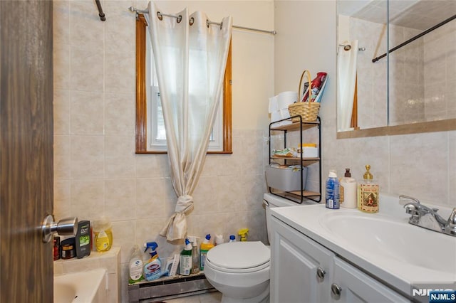bathroom with vanity, toilet, a shower with curtain, and tile walls