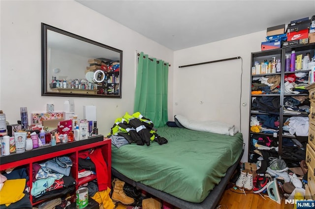 bedroom with wood finished floors