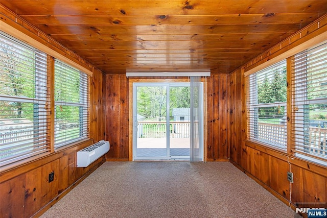 unfurnished sunroom with plenty of natural light and an AC wall unit
