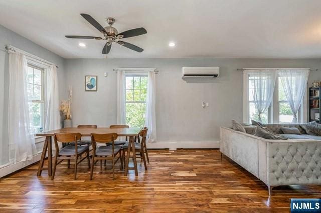 dining room with recessed lighting, a wall unit AC, ceiling fan, baseboards, and wood finished floors