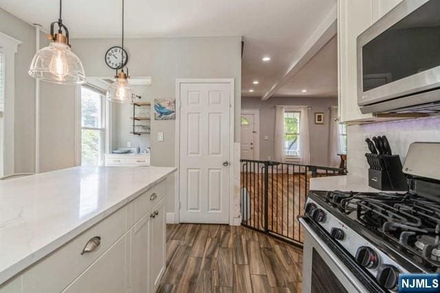 kitchen featuring recessed lighting, stainless steel appliances, white cabinetry, light countertops, and dark wood finished floors