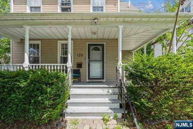 view of exterior entry featuring a porch