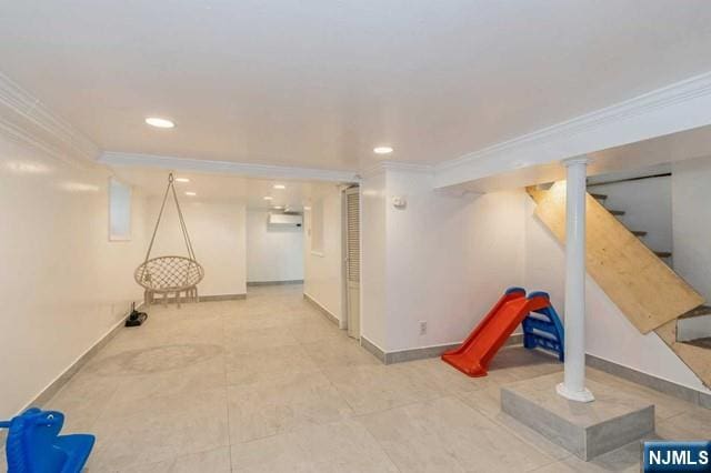 finished basement with baseboards, recessed lighting, stairs, and crown molding