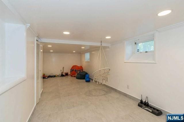 basement featuring crown molding, recessed lighting, and baseboards