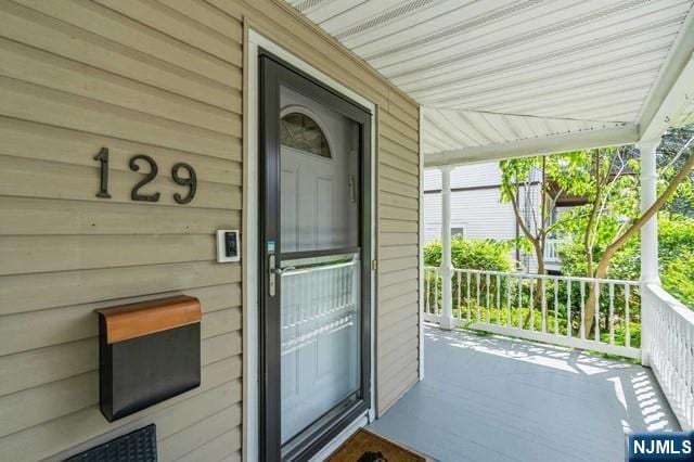 view of exterior entry featuring a porch