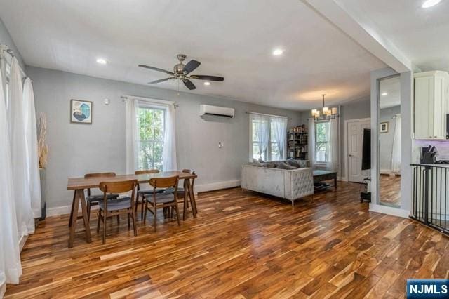 dining room with baseboards, recessed lighting, wood finished floors, and a wall mounted AC