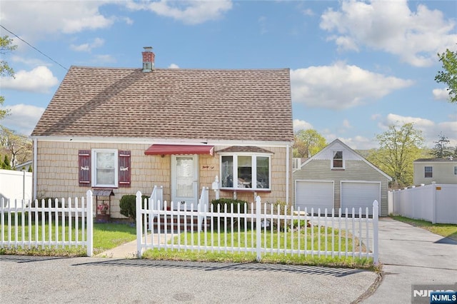 cape cod home with a garage, a shingled roof, a fenced front yard, and a chimney