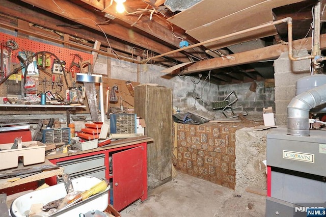 unfinished basement with a workshop area