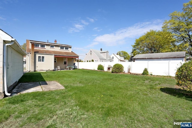 view of yard featuring a patio area and a fenced backyard