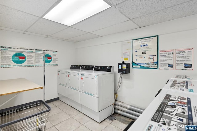 common laundry area featuring light tile patterned floors and washing machine and dryer