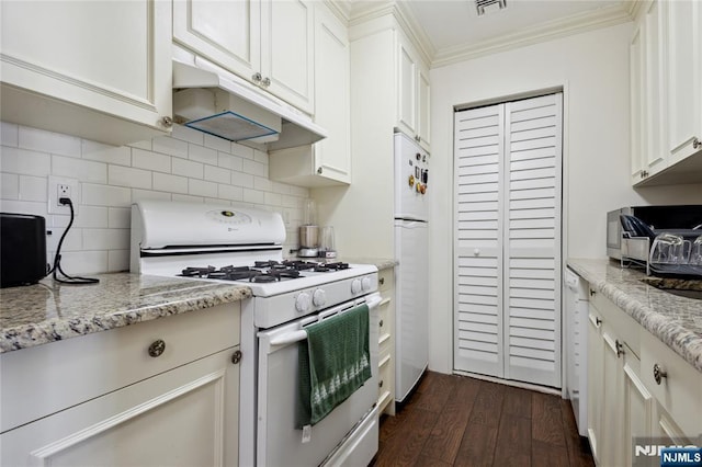 kitchen with dark wood finished floors, white appliances, decorative backsplash, under cabinet range hood, and crown molding