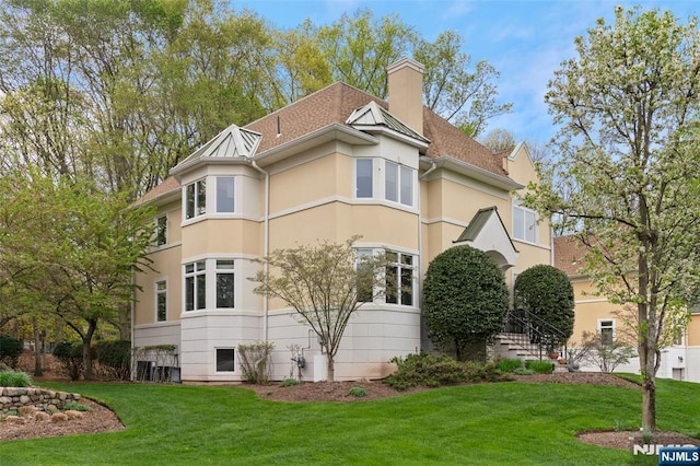 161 Winding Way, Old Tappan, NJ 07675 - view of side of property featuring stucco siding, a yard, a chimney, and a shingled roof