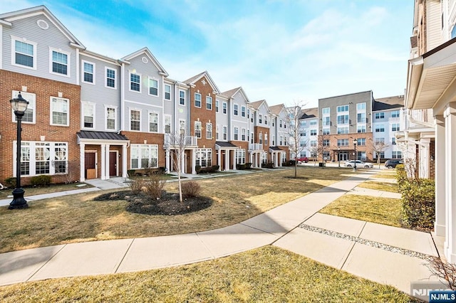 view of property's community featuring a residential view and a lawn