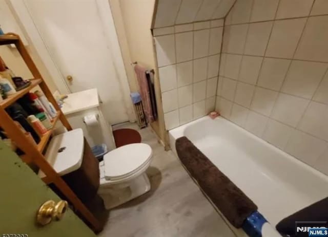 bathroom featuring walk in shower, toilet, and a bath