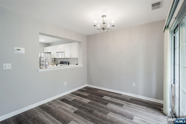 2304 Wendover Dr, Pequannock Township, NJ 07444 - unfurnished dining area with dark wood finished floors, baseboards, visible vents, and an inviting chandelier