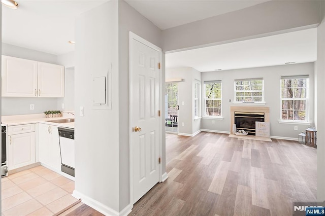 2304 Wendover Dr, Pequannock Township, NJ 07444 - kitchen with white cabinetry, light wood-style flooring, light countertops, white dishwasher, and open floor plan
