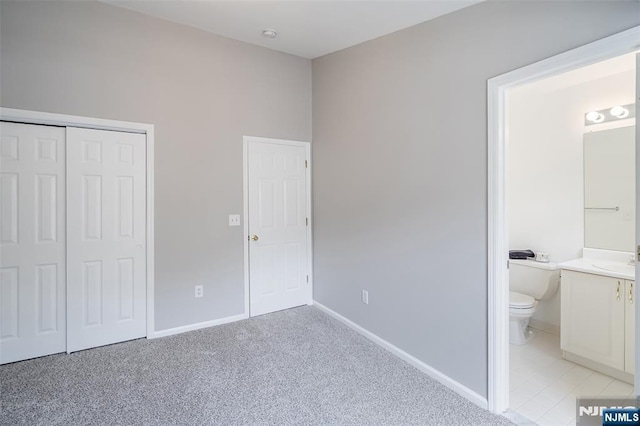 2304 Wendover Dr, Pequannock Township, NJ 07444 - unfurnished bedroom featuring a sink, a closet, light carpet, baseboards, and ensuite bathroom