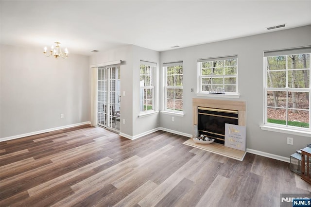 2304 Wendover Dr, Pequannock Township, NJ 07444 - unfurnished living room with a glass covered fireplace, a healthy amount of sunlight, wood finished floors, and visible vents