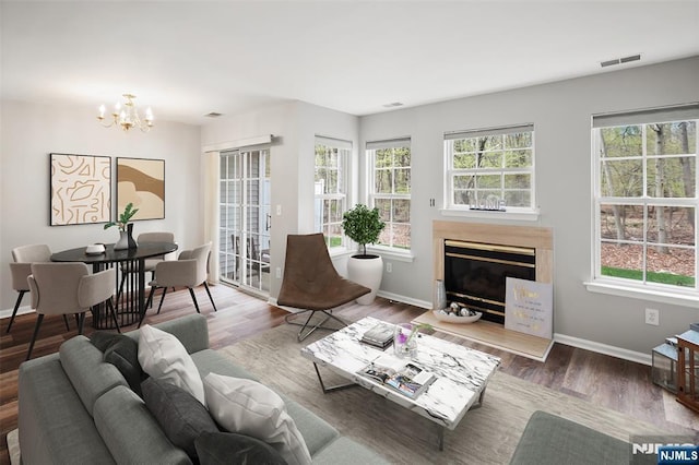 2304 Wendover Dr, Pequannock Township, NJ 07444 - living area featuring a wealth of natural light, visible vents, a glass covered fireplace, and a chandelier