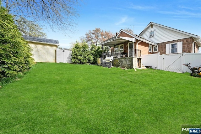 exterior space with a yard, a fenced backyard, and brick siding
