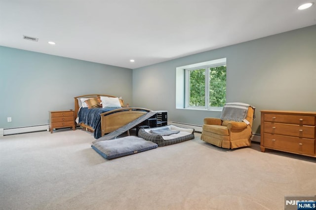 bedroom with a baseboard heating unit, recessed lighting, baseboard heating, and carpet floors