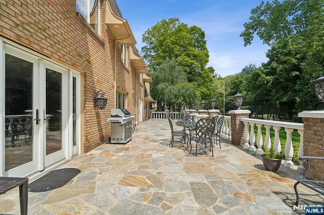 view of patio / terrace featuring french doors, area for grilling, and outdoor dining area