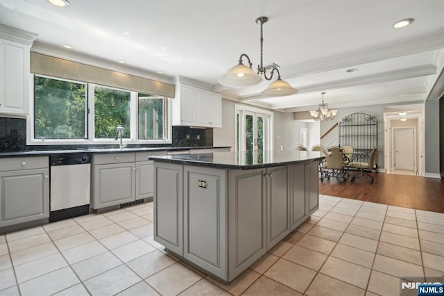 kitchen with gray cabinetry, light tile patterned floors, and stainless steel dishwasher