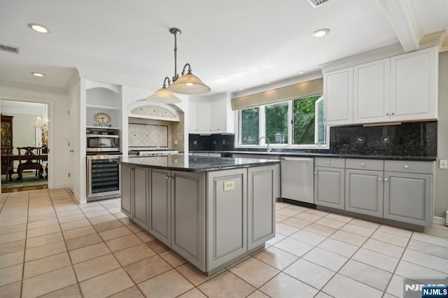 kitchen with light tile patterned flooring, gray cabinets, stainless steel appliances, and beverage cooler