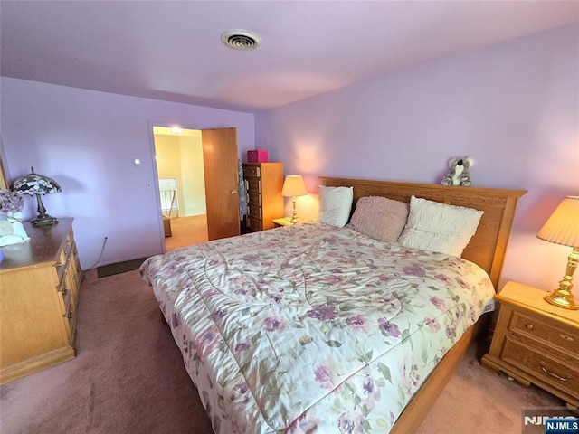 carpeted bedroom with visible vents
