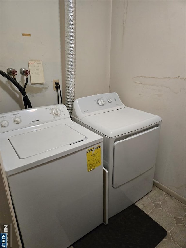 laundry room featuring separate washer and dryer and laundry area