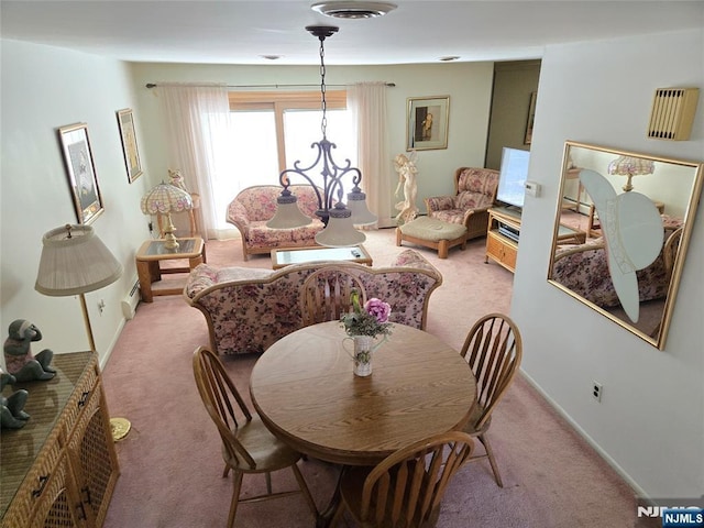 dining room featuring baseboards, baseboard heating, and light colored carpet
