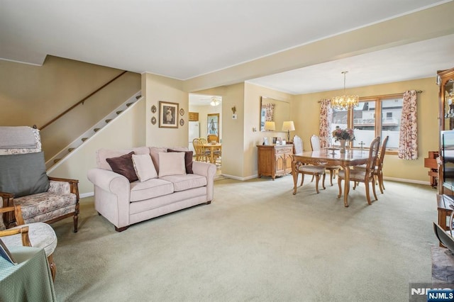 living area featuring an inviting chandelier, stairway, light colored carpet, and baseboards