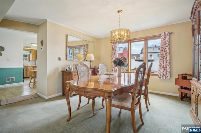 dining room featuring visible vents, an inviting chandelier, light colored carpet, and baseboards