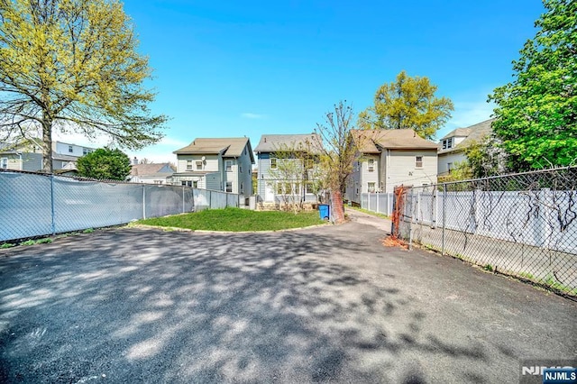 exterior space featuring fence and a residential view
